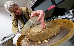 Nikolaus Wostry, head of Film Collections of Filmmarchiv Austria, shows an old damaged film at Filmarchiv Austria in Laxenburg on November 15, 2016. (AFP PHOTO / JOE KLAMAR)
