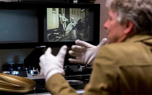 Nikolaus Wostry, head of Film Collections of Filmmarchiv Austria, shows the movie' The City Without Jews' at Filmarchive Austria in Laxenburg on November 15, 2016. (AFP PHOTO / JOE KLAMAR)