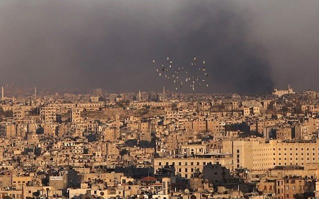 A general view taken from the government-held side of Aleppo shows smoke billowing during fighting between Syrian regime forces and rebel fighters in east Aleppo, on December 3, 2016. (AFP PHOTO / Youssef KARWASHAN) A general view taken from the government-held side of Aleppo shows smoke billowing during fighting between Syrian regime forces and rebel fighters in east Aleppo, on December 3, 2016. (AFP PHOTO / Youssef KARWASHAN)