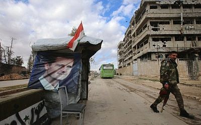 A Syrian pro-government fighter patrols next to a checkpoint in the Shihan neighbourhood in the government-held side of Aleppo, on December 3, 2016. (AFP Photo/Youssef Karwashan)