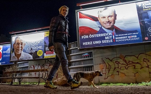 A man walks his dog around a park where Election posters of Austrian Presidential election candidates Norbert Hofer (R) of the Freedom Party Austria FPOe, and independent Alexander Van der Bellen (L) are seen in Vienna, Austria on December 3, 2016. (AFP PHOTO/JOE KLAMAR) A man walks his dog around a park where Election posters of Austrian Presidential election candidates Norbert Hofer (R) of the Freedom Party Austria FPOe, and independent Alexander Van der Bellen (L) are seen in Vienna, Austria on December 3, 2016. (AFP PHOTO/JOE KLAMAR)