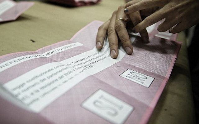 Scrutineers count the ballots at the end of the vote for a referendum on constitutional reforms, on December 4, 2016 in a polling station in Saluzzo near Turin. (AFP/ MARCO BERTORELLO)