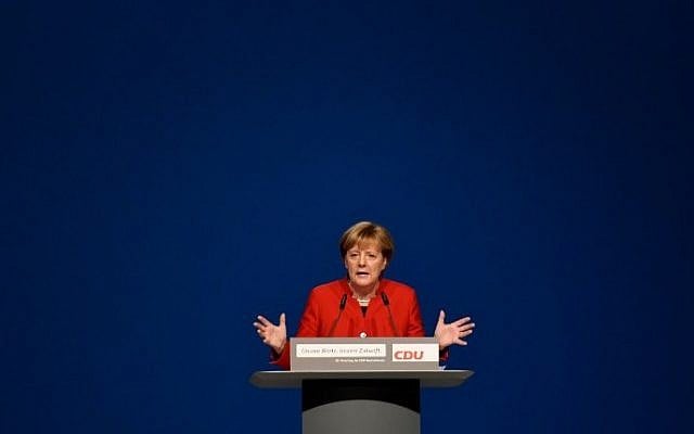 German Chancellor Angela Merkel addresses delegates during her conservative Christian Democratic Union (CDU) party's congress in Essen, western Germany, on December 6, 2016. (AFP PHOTO/PATRIK STOLLARZ)