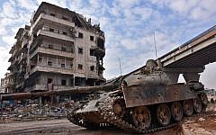 Syrian government troops patrol the newly captured al-Sakhour neighborhood in the eastern part of the northern city of Aleppo on December 7, 2016. (AFP /GEORGE OURFALIAN)