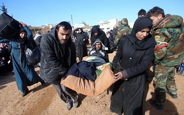 Syrian residents fleeing the violence gather at a checkpoint, manned by pro-government forces, in the village of Aziza on the southwestern outskirts of the northern Syrian city of Aleppo on December 8, 2016. (AFP/ Youssef KARWASHAN) Syrian residents fleeing the violence gather at a checkpoint, manned by pro-government forces, in the village of Aziza on the southwestern outskirts of the northern Syrian city of Aleppo on December 8, 2016. (AFP/ Youssef KARWASHAN)