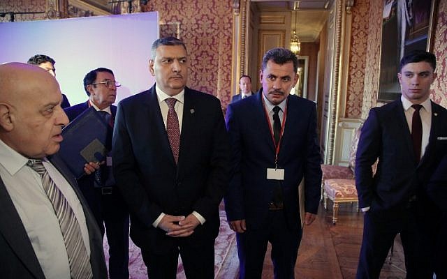 Chief Negotiator for the Syrian Opposition Riad Hijab (C-L) and Local Council of Aleppo president Brita Hagi Hassan (C-R) arrive for a meeting on the Syrian conflict in Paris on December 10, 2016. (AFP PHOTO/POOL/Thibault Camus