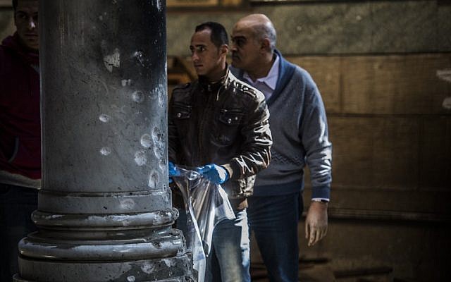 Egyptian security forces inspect the scene of a bomb explosion at the Saint Peter and Saint Paul Coptic Orthodox Church on December 11, 2016, in Cairo's Abbasiya neighborhood. (AFP PHOTO / KHALED DESOUKI)