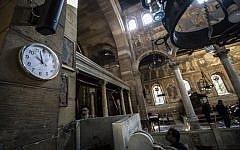 Egyptian security forces and members of the clergy inspect the scene of a bomb explosion at the Saint Peter and Saint Paul Coptic Orthodox Church on December 11, 2016, in Cairo's Abbasiya neighbourhood. (AFP PHOTO / KHALED DESOUKI)