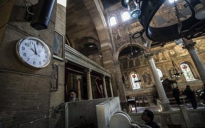 Egyptian security forces and members of the clergy inspect the scene of a bomb explosion at the Saint Peter and Saint Paul Coptic Orthodox Church on December 11, 2016, in Cairo's Abbasiya neighbourhood. (AFP PHOTO / KHALED DESOUKI)