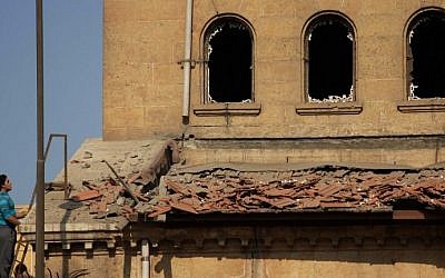 An Egyptian man looks at the damage at the scene of a bomb explosion that targeted the Saint Peter and Saint Paul Coptic Orthodox Church in Cairo on December 11, 2016, in which at least 25 were killed. (Suhail Saleh/AFP Photo)