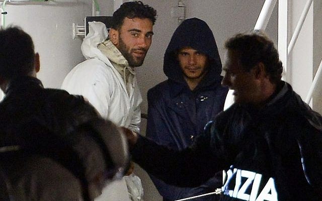 This photo taken on April 20, 2015 shows two men, identified as Mohammed Ali Malek (2nd L), one of the survivors and understood to be the captain of the boat that overturned off the coasts of Libya, and a man identified as Mahmud Bikhit (2nd R), another survivor and understood to be a crew member of the boat, standing onboard the Italian Coast Guard vessel Bruno Gregoretti at Boiler Wharf, Senglea, in Malta. (AFP PHOTO / ALBERTO PIZZOLI) This photo taken on April 20, 2015 shows two men, identified as Mohammed Ali Malek (2nd L), one of the survivors and understood to be the captain of the boat that overturned off the coasts of Libya, and a man identified as Mahmud Bikhit (2nd R), another survivor and understood to be a crew member of the boat, standing onboard the Italian Coast Guard vessel Bruno Gregoretti at Boiler Wharf, Senglea, in Malta. (AFP PHOTO / ALBERTO PIZZOLI)