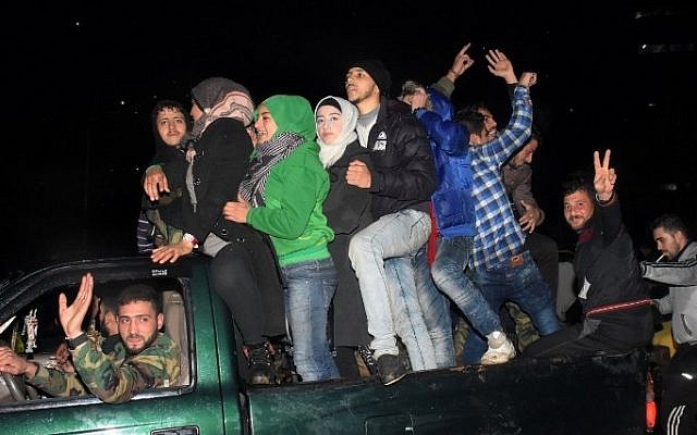 Syrians celebrate on December 12, 2016 in the government-held Mogambo neighbourhood of the northern Syrian city of Aleppo, after rebel fighters retreated into a small pocket of their former bastion in the face of new army advances. (AFP PHOTO / George OURFALIAN) Syrians celebrate on December 12, 2016 in the government-held Mogambo neighbourhood of the northern Syrian city of Aleppo, after rebel fighters retreated into a small pocket of their former bastion in the face of new army advances. (AFP PHOTO / George OURFALIAN)