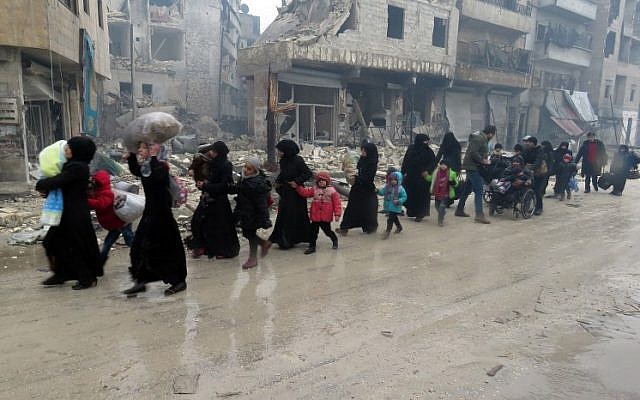 Syrian residents, fleeing violence in the restive Bustan al-Qasr neighbourhood, arrive in Aleppo's Fardos neighborhood on December 13, 2016, after regime troops retook the area from rebel fighters. (AFP/STRINGER) Syrian residents, fleeing violence in the restive Bustan al-Qasr neighbourhood, arrive in Aleppo's Fardos neighborhood on December 13, 2016, after regime troops retook the area from rebel fighters. (AFP/STRINGER)