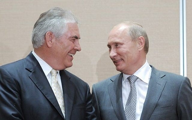 This file photo taken on August 30, 2011 shows Russia's then Prime Minister Vladimir Putin speaking with ExxonMobil President and CEO Rex Tillerson during the signing of a Rosneft-ExxonMobil strategic partnership agreement in Sochi. (AFP PHOTO/RIA NOVOSTI/ALEXEY DRUZHININ)
