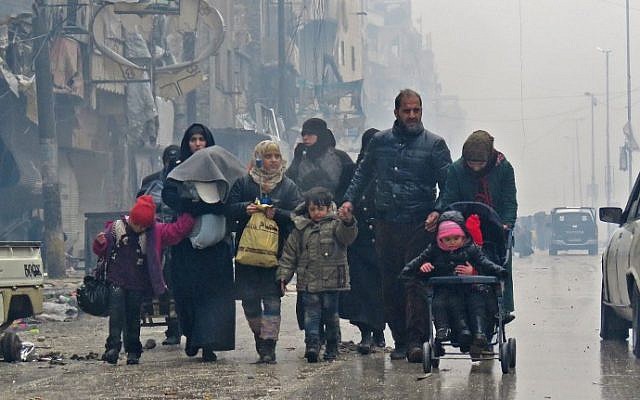 Syrian residents, fleeing violence in the restive Bustan al-Qasr neighborhood, arrive in Aleppo's Fardos neighborhood on December 13, 2016, after regime troops retook the area from rebel fighters. (AFP PHOTO / STRINGER) Syrian residents, fleeing violence in the restive Bustan al-Qasr neighborhood, arrive in Aleppo's Fardos neighborhood on December 13, 2016, after regime troops retook the area from rebel fighters. (AFP PHOTO / STRINGER)