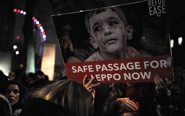 Protesters hold placards during a demonstration in solidarity with the inhabitants of the embattled Syrian city of Aleppo, outside the entrance to Downing Street, in central London on December 13, 2016.(AFP PHOTO / DANIEL SORABJI) Protesters hold placards during a demonstration in solidarity with the inhabitants of the embattled Syrian city of Aleppo, outside the entrance to Downing Street, in central London on December 13, 2016.(AFP PHOTO / DANIEL SORABJI)