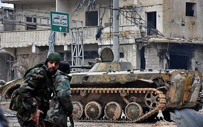 Syrian pro-government forces patrol the northern embattled city of Aleppo on December 14, 2016. (AFP PHOTO/George OURFALIAN)