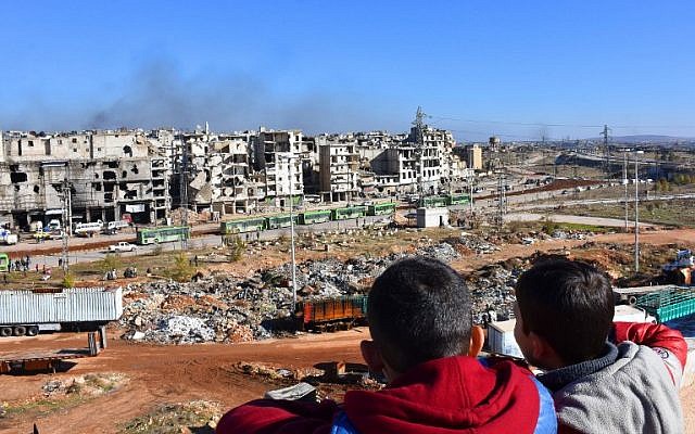 Syrian children watch on as buses depart during an evacuation operation of rebel fighters and their families from rebel-held neighborhoods in the embattled city of Aleppo on December 15, 2016 (AFP PHOTO / George OURFALIAN) Syrian children watch on as buses depart during an evacuation operation of rebel fighters and their families from rebel-held neighborhoods in the embattled city of Aleppo on December 15, 2016 (AFP PHOTO / George OURFALIAN)