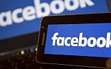 This file photo taken on November 21, 2016, shows Facebook logos pictured on the screens of a smartphone (R), and a laptop computer, in central London. (AFP)