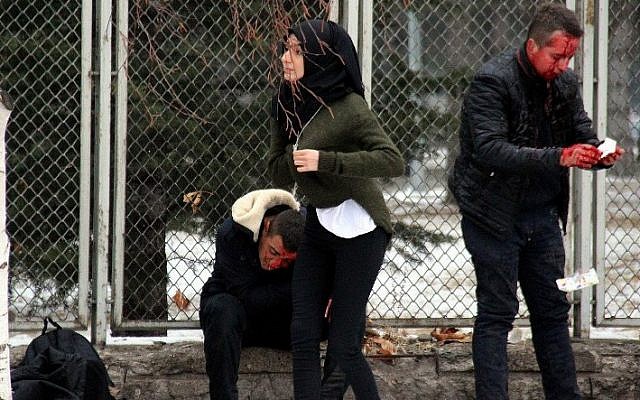 This picture obtained from the Ihlas News Agency shows injured people waiting for an ambulance following an explosion in Kayseri, central Turkey on December 17, 2016. (AFP/Ihlas News Agency)