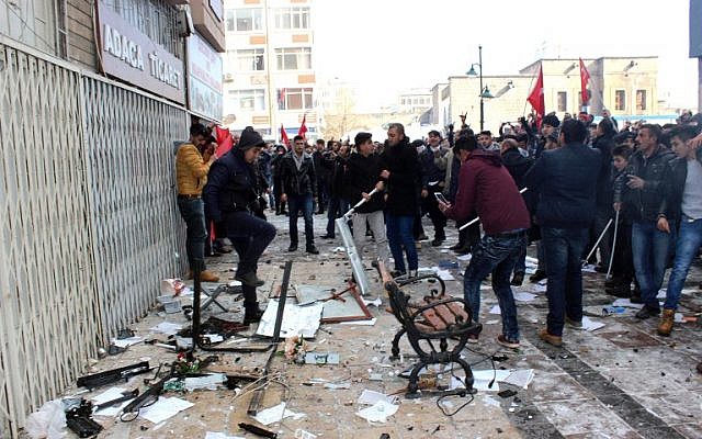 This picture obtained from Dogan News Agency shows people protesting in front of the offices of pro-Kurdish Peoples' Democratic Party (HDP) following a suicide car bombing in Kayseri on December 17, 2016. (AFP PHOTO/DOGAN NEWS AGENCY)