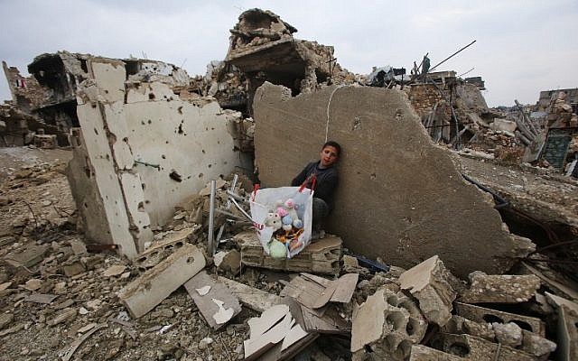 A Syrian boy sits with belongings he collected from the rubble of his house in Aleppo's Al-Arkoub neighborhood on December 17, 2016, after pro-government forces retook the area from rebel fighters. (AFP/Youssef Karwashan) A Syrian boy sits with belongings he collected from the rubble of his house in Aleppo's Al-Arkoub neighborhood on December 17, 2016, after pro-government forces retook the area from rebel fighters. (AFP/Youssef Karwashan)