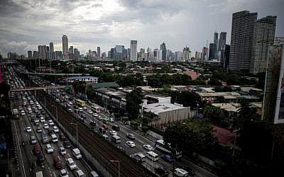 This picture taken on September 30, 2016 shows a general view of traffic as Manila's financial district is seen in the background. (AFP PHOTO / NOEL CELIS)