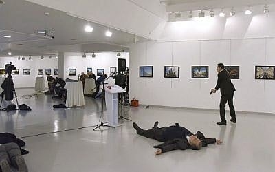 This picture taken on December 19, 2016 shows Andrei Karlov (2ndR), the Russian ambassador to Ankara, lying on the floor after being shot by Mevlut Mert Altintas (R) during an attack during a public event in Ankara. (AFP PHOTO / Sozcu daily / Yavuz Alatan)