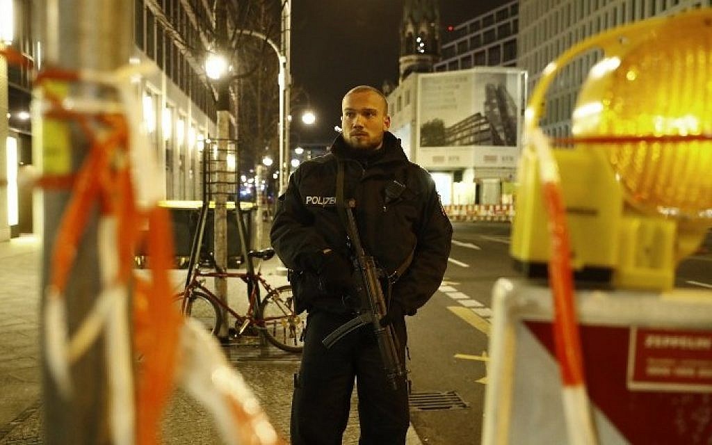 Police blocks a road leading to the site next to the Gedächniskirche church (background)  where a truck crashed into a christmas market in Berlin, on December 19, 2016 killing at least nine people and injuring at least 50 people. (AFP PHOTO / Odd ANDERSEN)
