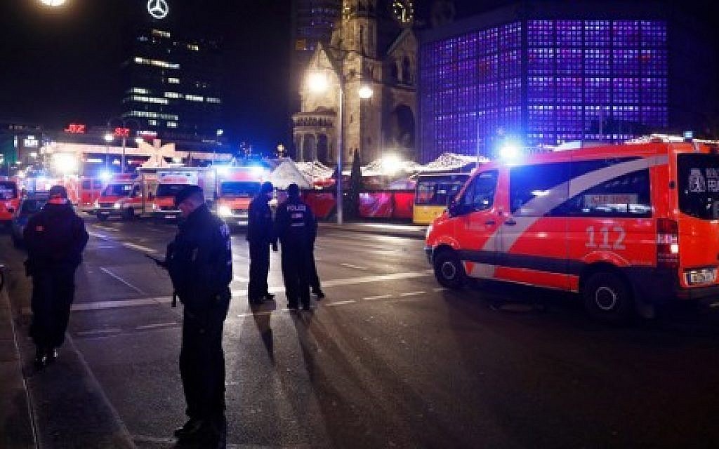 Police and ambulances are standing around the site next to the Gedächniskirche church (background) where a truck crashed into a Christmas market in Berlin, on December 19, 2016 killing at least nine people and injuring at least 50 people. (AFP PHOTO / Odd ANDERSEN)