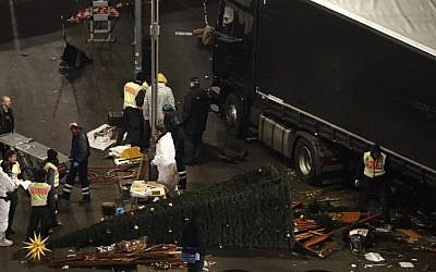 Forensic police officers work on December 20, 2016 at the scene where a truck rammed into a Christmas market near the Kaiser Wilhelm Memorial Church in Berlin, killing at least 12 people. (Odd Andersen/AFP)