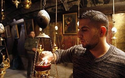 A man lights incense at the Church of the Nativity, believed to be the birthplace of Jesus Christ, in the West Bank city of Bethlehem on December 20, 2016. (AFP PHOTO / MUSA AL SHAER)