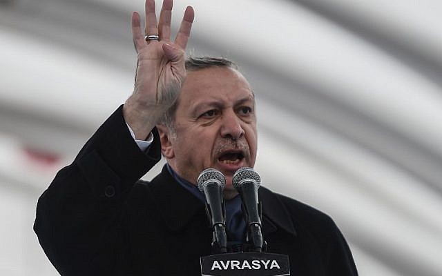Turkish President Recep Tayyip Erdogan gestures as he delivers a speech on December 20, 2016 in Istanbul, during the opening ceremony of the Avrasya (Eurasia) Tunnel, the first ever road tunnel underneath the Bosphorus Strait in Istanbul from Europe to Asia and the latest project in the Erdogan's plan of transforming Turkey's infrastructure. (AFP PHOTO / OZAN KOSE)