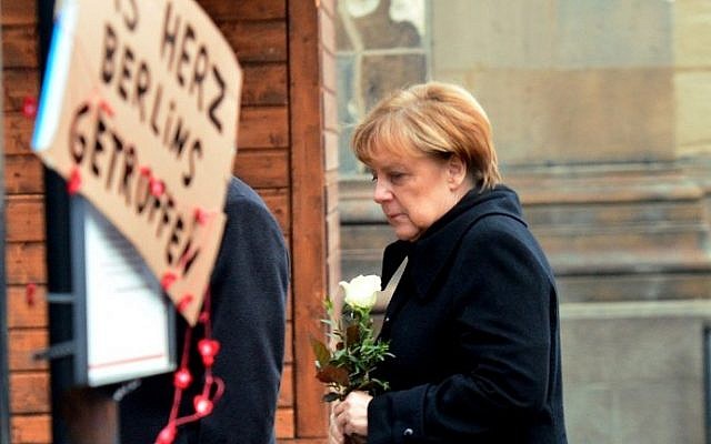 German Chancellor Angela Merkel arrives on December 20, 2016 at the site where a truck crashed into a Christmas market near the Kaiser-Wilhelm-Gedaechtniskirche (Kaiser Wilhelm Memorial Church) in Berlin. (AFP PHOTO / DPA / Maurizio Gambarini)