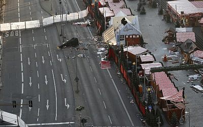 View of the Christmas market area and the destroyed booths targeted by an attack with a truck two days ago in front of the Kaiser Wilhelm Memorial Church in Berlin on December 21, 2016. (AFP Photo/Odd Andersen)