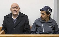 Arab MK Basel Ghattas attends a remand hearing at Rishon Lezion Magistrate's Court on December 23, 2016, a day after he was arrested for allegedly passing cell phones to convicted terrorists jailed in Israel. (AFP PHOTO/JACK GUEZ)