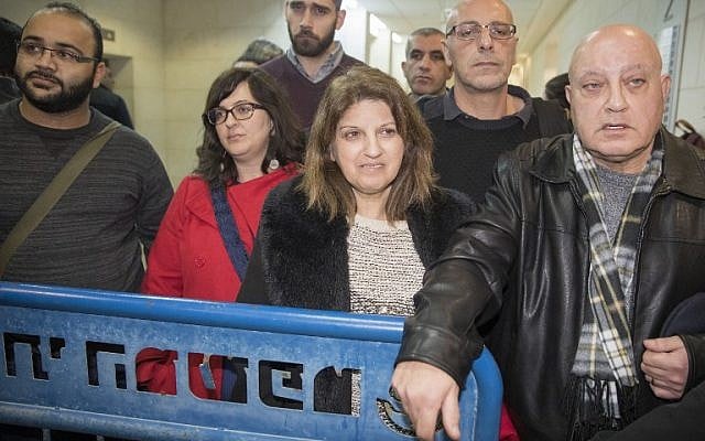 Sawsan Ghattas (C), the wife of Arab MK Basel Ghattas, attends a remand hearing at Rishon Lezion Magistrate's Court on December 23, 2016, a day after he was arrested for allegedly passing cell phones to convicted terrorists jailed in Israel. (AFP PHOTO/JACK GUEZ) 