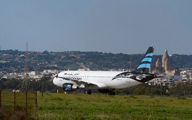 A picture taken on December 23, 2016 shows a hijacked Airbus A320 operated by Afriqiyah Airways after it landed at Luqa Airport, in Malta. (AFP/Matthew Mirabelli)
