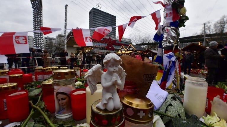 Candles, flowers and individual messages are placed at a makeshift memorial for the victims of the Christmas market attack near the Kaiser Wilhelm Memorial Church in Berlin on December 24, 2016. (AFP Photo/John Macdougall) Candles, flowers and individual messages are placed at a makeshift memorial for the victims of the Christmas market attack near the Kaiser Wilhelm Memorial Church in Berlin on December 24, 2016. (AFP Photo/John Macdougall)