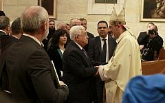 Palestinian Authority President  Mahmoud Abbas congratulates Archbishop Pierbattista Pizzaballa (R), apostolic administrator of the Latin Patriarch of Jerusalem, during the Christmas Midnight Mass in Saint Catherine's Church at the Church of the Nativity, on December 25, 2016 in Bethlehem, West Bank (AFP PHOTO AND POOL / MUSA AL SHAER)