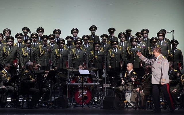 This file photo taken on October 23, 2015 shows the official army choir of the Russian armed forces, also known as the Alexandrov Ensemble, standing while the choir conductor General Viktor Eliseev, right, arrives onstage at the Palais des Sports in Paris. (AFP /Jacques DEMARTHON)