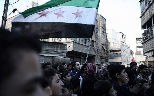 Syrian men gather in the rebel-held town of Saqba, on the eastern outskirts of the capital Damascus, during a demonstration against the Syrian regime, on December 30, 2016, on the first day of a nationwide truce. (AFP/Sameer Al-Doumy) Syrian men gather in the rebel-held town of Saqba, on the eastern outskirts of the capital Damascus, during a demonstration against the Syrian regime, on December 30, 2016, on the first day of a nationwide truce. (AFP/Sameer Al-Doumy)
