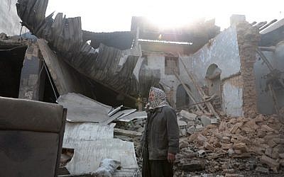 Syrian Abu Khaled stands amid the rubble of his destroyed house in the rebel-held town of Douma, on the eastern outskirts of Damascus, on December 30, 2016, on the first day of a nationwide truce. (AFP PHOTO/Abd Doumany)