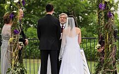 Rabbi Seymour Rosenbloom officiating at the wedding of his stepdaughter and her fiance in 2014. (Courtesy of Stefanie Fox via JTA)