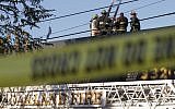 Firefighters investigate the scene of a overnight fire that claimed the lives of at least nine people during a warehouse party in the Fruitvale neighborhood on December 3, 2016 in Oakland, California. (Elijah Nouvelage/Getty Images/AFP)