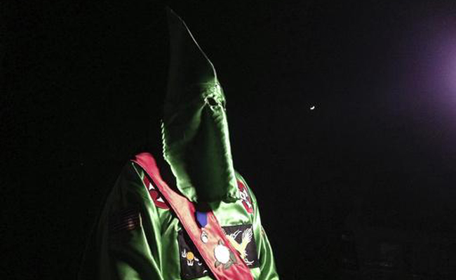 A robed and masked Ku Klux Klansmen stands on a muddy dirt road during an interview near Pelham, NC on Dec. 2, 2016. (AP Photo/Jay Reeves) A robed and masked Ku Klux Klansmen stands on a muddy dirt road during an interview near Pelham, NC on Dec. 2, 2016. (AP Photo/Jay Reeves)