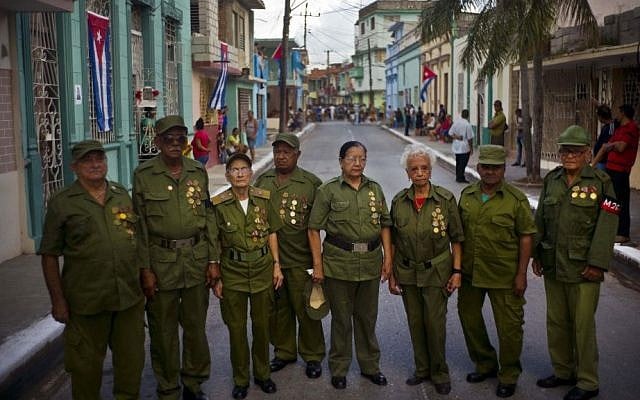 Seniors who were part of Fidel Castro's rebel force during Cuba's revolution pose for a group portrait, before Castro's funeral procession passes through Bayamo, Cuba, Friday, December 2, 2016. (AP Photo/Ramon Espinosa)