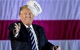 President-elect Donald Trump throws a hat into the audience while speaking at a rally in a DOW Chemical Hanger at Baton Rouge Metropolitan Airport, Friday, Dec. 9, 2016, in Baton Rouge, La. (AP Photo/Andrew Harnik)