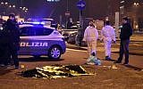 The body of suspected Berlin attacker Ani Amri is covered with a blanket after a shootout near a train station in Milan's Sesto San Giovanni neighborhood, Italy, early Friday, December 23, 2016. (AP Photo/Daniele Bennati)