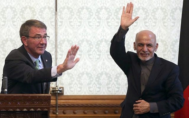 Afghan President Ashraf Ghani, right, and US Defense Secretary Ash Carter, left, wave after a press conference at presidential palace in Kabul, Afghanistan, Friday, Dec. 9, 2016. (AP Photos/Massoud Hossaini)
